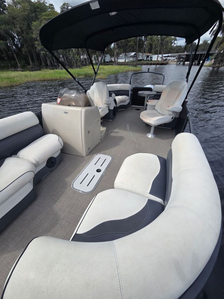 Inside Name That Toon: wraparound lounge seating, helm and captain's chairs under the bimini top