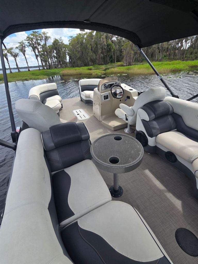 Rear lounge seating and table aboard Name That Toon, a Premier tritoon pontoon